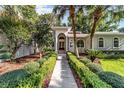 Beautiful home exterior with lush landscaping and a walkway leading to the entrance at 6943 Se 12Th Cir, Ocala, FL 34480