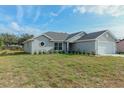 Newly constructed home with gray siding and a two-car garage at 7051 Sw 64Th Ter, Ocala, FL 34476