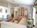 Bright living room with hardwood floors, hutch, and comfortable seating area at 5958 Sw 102Nd Ln, Ocala, FL 34476