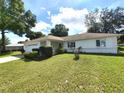 Ranch style home features a spacious yard and attached garage at 5958 Sw 102Nd Ln, Ocala, FL 34476