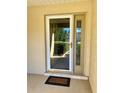 Front door with storm door and welcome mat at 10787 Sw 53Rd Cir, Ocala, FL 34476