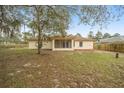 Backyard of house with screened patio and large yard at 2312 Sw 140Th Ct, Ocala, FL 34481