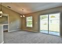 Bright dining room with patio access and carpeting at 12472 Sw 85Th Pl, Dunnellon, FL 34432