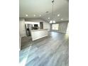 Modern kitchen with stainless steel appliances and an island at 6044 Nw 65Th Pl, Ocala, FL 34482