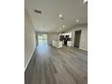 Open concept living room and kitchen with gray vinyl flooring at 6044 Nw 65Th Pl, Ocala, FL 34482