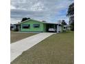 Light green single-story home with carport at 10300 Sw 98Th Ter, Ocala, FL 34481