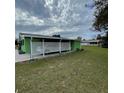 Carport and side yard of a light green home at 10300 Sw 98Th Ter, Ocala, FL 34481