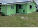 Rear view of a light green single-story home at 10300 Sw 98Th Ter, Ocala, FL 34481