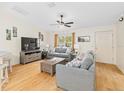 Living room with gray sofas, coffee table, and TV at 7994 Se 174Th Belhaven Loop, The Villages, FL 32162