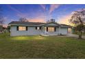 Ranch style home with a covered porch and well-maintained lawn at 10881 Sw 79Th Ter, Ocala, FL 34476