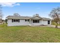 Ranch-style home with a carport and well-maintained lawn at 10881 Sw 79Th Ter, Ocala, FL 34476