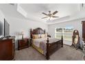 Spacious bedroom with a large bed, dresser, and plenty of natural light at 3235 Se 43Rd Ave, Ocala, FL 34480