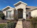 Front entry with walkway and well-maintained landscaping at 12900 Se 97Th Terrace Rd, Summerfield, FL 34491