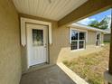 Front entry with decorative door and sidelights at 233 Locust Ln, Ocala, FL 34472
