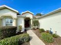 House exterior featuring a front porch and manicured landscaping at 15338 Sw 14Th Avenue Rd, Ocala, FL 34473