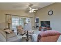 Spacious living room with ample seating and large TV at 5247 Nw 18Th St, Ocala, FL 34482