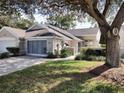 Front view of charming villa with two-car garage and landscaped lawn at 7929 Sw 115Th Loop, Ocala, FL 34476