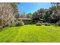 Single-story home with green lawn and covered carport at 3751 Se 3Rd Ave, Ocala, FL 34471