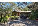 Single story home with carport and tropical landscaping at 3751 Se 3Rd Ave, Ocala, FL 34471