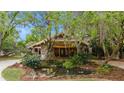 Home exterior featuring stone accents and lush landscaping at 2162 Se Mill Creek Cir, Ocala, FL 34471