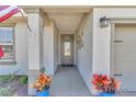 Covered front entryway with gray door and blue potted plants at 5662 Nw 40Th Pl, Ocala, FL 34482