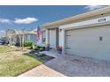 Front view of a one-story house with a gray garage door and American flag at 5662 Nw 40Th Pl, Ocala, FL 34482