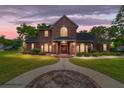 Brick house exterior at dusk with walkway and landscaping at 7086 Se 12Th Cir, Ocala, FL 34480