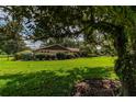 House partially obscured by tree, lush lawn at 735 Se 22Nd Ave, Ocala, FL 34471