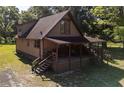 A frame home with covered porch and yard at 13881 Ne Jacksonville Rd, Citra, FL 32113