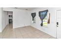 Bright and airy living room with tile floors and two windows at 6839 Sw 149Th Lane Rd, Ocala, FL 34473