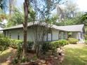 One-story house with a landscaped yard and mature trees at 16789 Se 69Th Ln, Ocklawaha, FL 32179