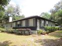 Ranch style home with screened porch and manicured hedges at 16789 Se 69Th Ln, Ocklawaha, FL 32179