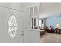 Entryway with an oval window and view into the living room at 612 Fannich Ct, Leesburg, FL 34788