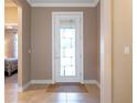 Bright entryway with tiled floor, white door, and a view of a bedroom at 6376 Sw 97Th Terrace Rd, Ocala, FL 34481