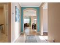 Hallway with teal accent wall, rug, and view into living area at 6376 Sw 97Th Terrace Rd, Ocala, FL 34481