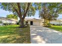 White brick ranch home with a two-car garage and a well-manicured lawn at 9145 Sw 90Th St, Ocala, FL 34481