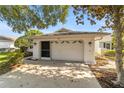 White two-car garage with an attached screened enclosure at 9145 Sw 90Th St, Ocala, FL 34481