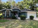 Single story home with a two-car garage, freshly painted exterior and landscaping at 19748 Sw 93Rd Ln, Dunnellon, FL 34432