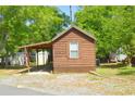 Rustic wooden cabin exterior with covered porch at 25235 Ne 142Nd Ne Ln # Lot 185, Salt Springs, FL 32134