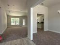 Spacious living room with carpeted floors and views to backyard at 11600 Sw 55Th Ave, Ocala, FL 34476