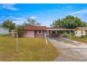 Front view of a pink single-story house with a carport at 46 Lake Court Loop, Ocala, FL 34472