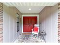 Inviting front porch with red door and rocking chair at 5240 Se 17Th St, Ocala, FL 34471