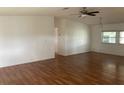 Spacious living room with light wood laminate flooring and ceiling fan at 24822 Pine Hl, Leesburg, FL 34748