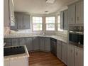 Gray kitchen with ample cabinetry, granite countertops, and stainless steel appliances at 24822 Pine Hl, Leesburg, FL 34748