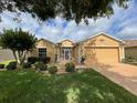 House with manicured lawn, landscaping, and a large tree at 16026 Sw 14Th Avenue Rd, Ocala, FL 34473