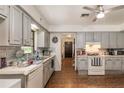 Galley style kitchen with grey cabinets and a view of the hallway at 15669 Se 112Th Ln, Ocklawaha, FL 32179