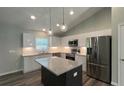 Modern kitchen with white cabinets, granite island, and stainless steel appliances at Tbd Fisher Lane Trak, Ocklawaha, FL 32179