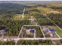 Aerial view of a new construction home on a wooded lot at 13359 Sw 80Th St, Dunnellon, FL 34432