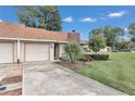 Tan house with a driveway and landscaping at 2309 Se 19Th Cir, Ocala, FL 34471