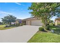 Single-story home with two-car garage and beautiful landscaping at 10145 Sw 89Th Loop, Ocala, FL 34481